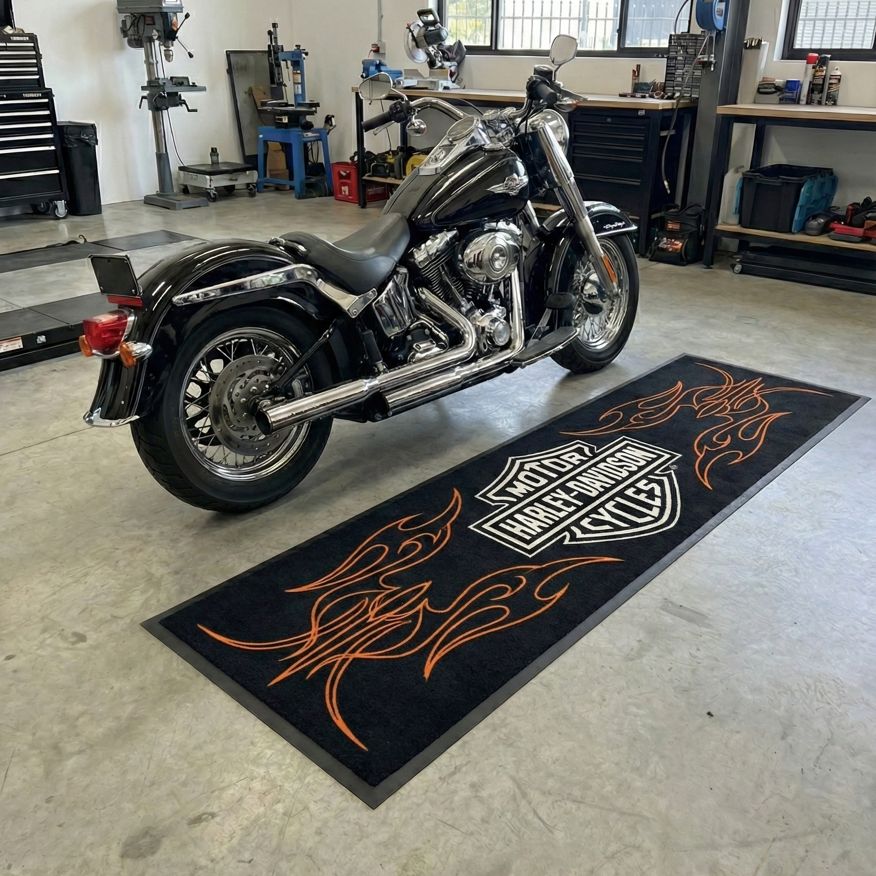 Harley Davidson motorcycle on a branded mat in a garage setting
